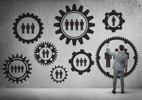 Businessman standing with back and drawing concept of teamwork and cooperation