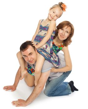 Father , mother and little daughter playing on the floor. Daughter and mom sat in dad's back while dad depicts a horse-Isolated on white background