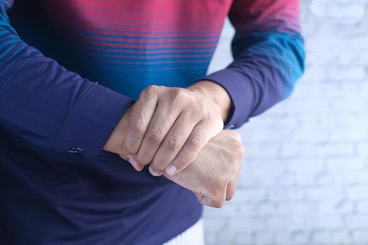 man suffering pain in hand close up .