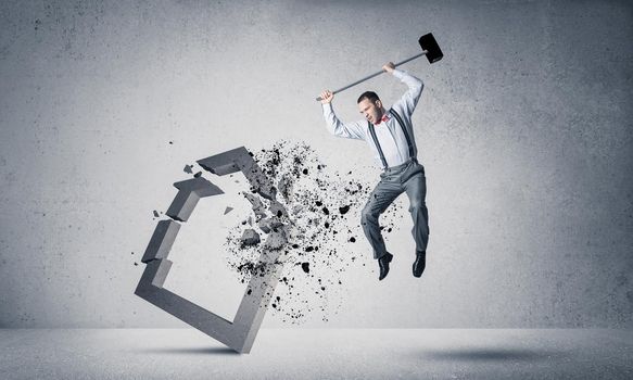 Determined businessman jumping and breaking with hammer house concrete figure