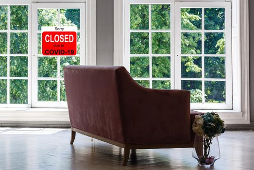 Business center closed due to COVID-19, sign with sorry in door window. Stores, restaurants, offices, other public places temporarily closed during coronavirus pandemic. Economy hit by corona virus.