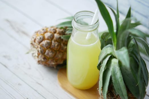 pineapple juice in a bottle on table .