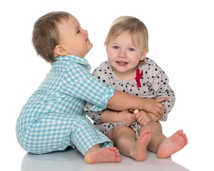 Toddler boy and girl, cute hugging in studio on a white background. The concept of a harmonious development of a child in the family, a happy childhood. Isolated.