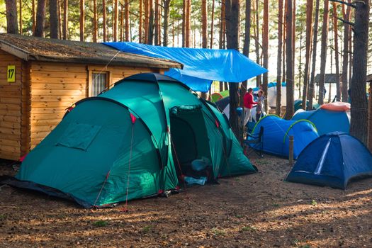 Belarus, Minsk region - June 29, 2019: Camp in the forest outdoor, travel and vacation in tents lifestyle, camping.