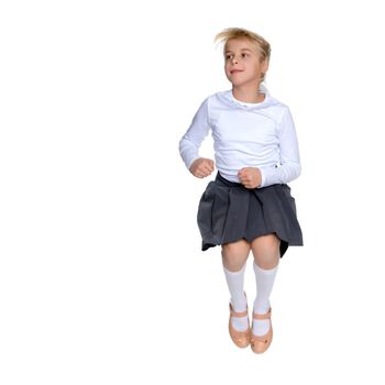 A little girl is jumping and waving her hands. The concept of a happy childhood, outdoor recreation. Isolated on white background.