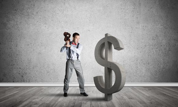 Young furious businessman going to crash with violin stone dollar symbol