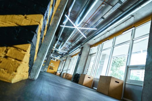 Modern empty gym with crossfit equipment, selective focus on wooden fitness boxes on the floor. Sport concept, health club interior