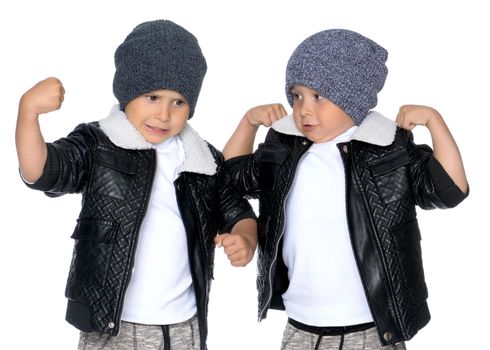 Studio portrait of boys in black leather jackets.Isolated on white background.