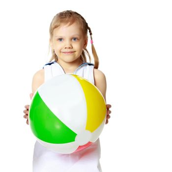 A nice little girl is playing with a big inflatable ball. The concept of a happy childhood, family recreation in nature, fitness and exercise. Isolated on white background.