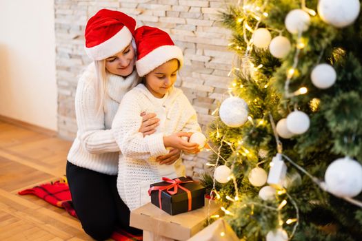 Christmas, happy family mother with daughter with gifts on Xmas Eve