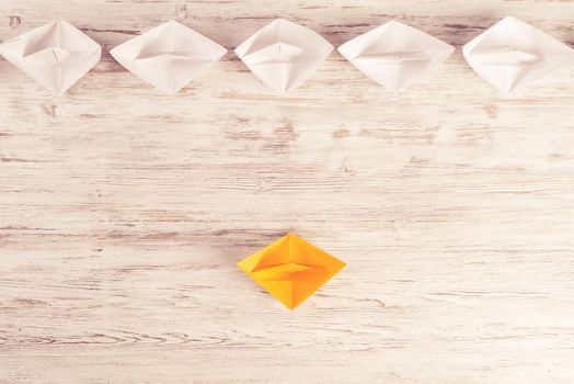 Set of origami boats on wooden table