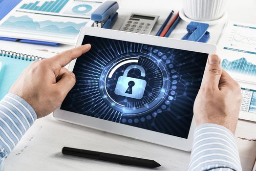 close-up, male hands with tablet. Businessman working at the table in office. computer security concept