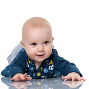 Sweetheart is a very small girl, who does not yet know how to walk, crawls on the floor. The concept of a happy childhood, the upbringing of a child. Isolated on white background.