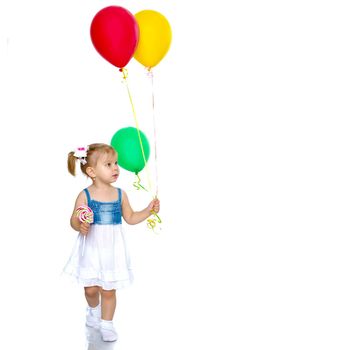 Little girl is playing with a balloon. The concept of the holiday, birthday. Isolated over white background