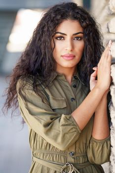 Young Arab Woman with curly hair in urban background