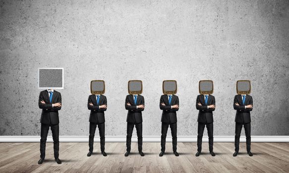 Businessmen in suits with old TV instead of their heads keeping arms crossed while standing in a row
