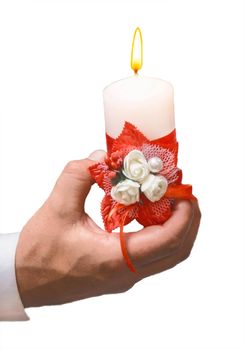 The man's hand holds a decorative light burning candle on a white background, an isolated, soft focus.