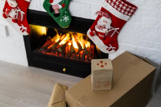 KYIV, UKRAINE - November 16, 2020: boxes Nova Poshta with delivery of Christmas gifts lie near the fireplace