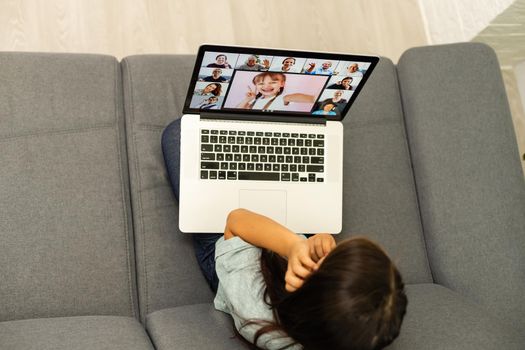 cheerful young little girl children using laptop computer, studying through online e-learning system