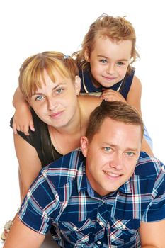 Cheerful young family of three. Mother and daughter lying on dad's back.Isolated on white background.