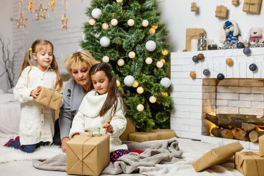 grandparents and children having fun during christmas day celebration at home with family.