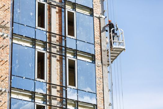 Suspended platform or cradle for construction, installation and repair work of building facades of skyscrapers.