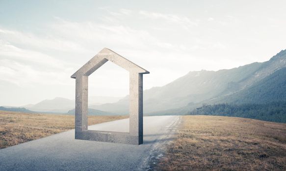 House stone figure as symbol of real estate outdoors against natural landscape