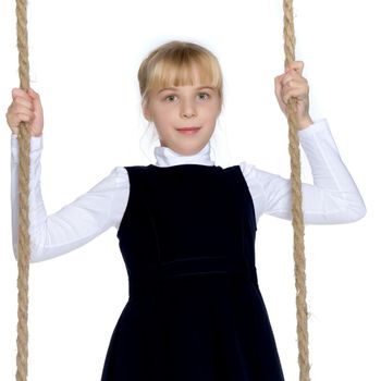 Beautiful little girl swinging on a swing. The concept of family happiness, summer holidays. Isolated on white background.