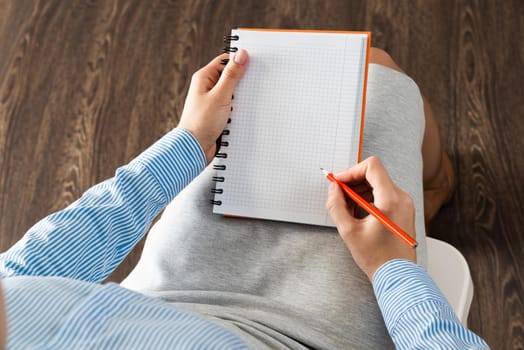 close-up a female hands with notebook and pencil