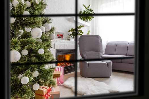 wiew through the window, Christmas Tree on background, winter holiday concept