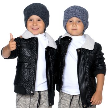 Studio portrait of boys in black leather jackets.Isolated on white background.