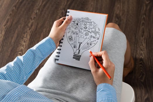 close-up, woman draws business notes in her notebook. Business Innovation Concept