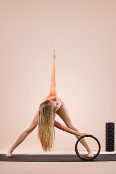 Portrait of a beautiful young woman sitting in yoga pose