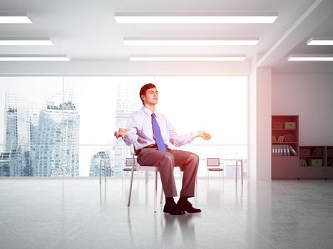 young businessman in the office meditates, achieve calmness, to achieve the goal