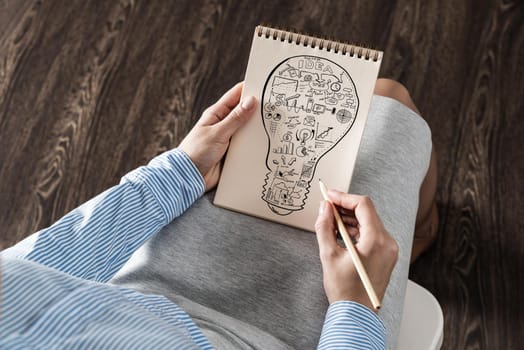 close-up, woman draws business notes in her notebook. Business Innovation Concept