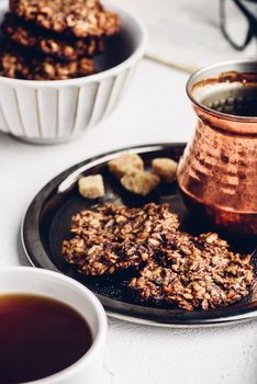 Banana oatmeal cookies with chocolate spread with turkish coffee on metal tray