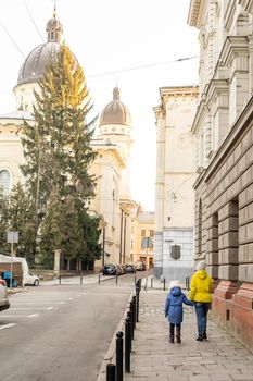 Mother and daughter are walking around the city on Christmas and New Year holidays.