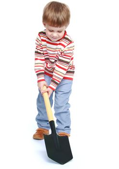 Little boy holding a shovel.Isolated on white background portrait.