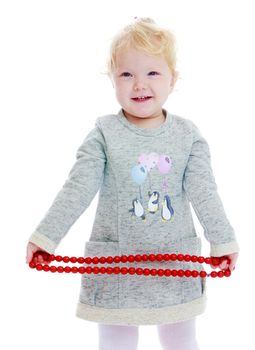 little girl.Charming girl with red beads in his hands