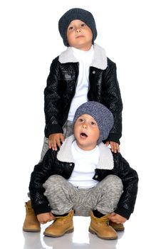 Studio portrait of boys in black leather jackets.Isolated on white background.