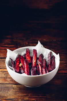 Oven baked beet fries in white bowl