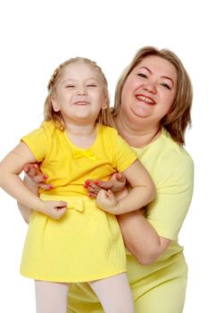 Mom and little daughter plus the size of the model, gently embrace. A woman and her daughter are smiling in a happy manner. Good for the concept of health, happiness, diet, obesity, weight loss.