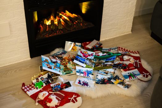 photo books lie near the fireplace at christmas