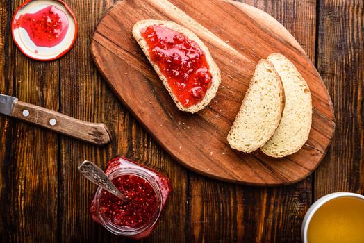 Toast with homemade raspberry jam with cup of green tea