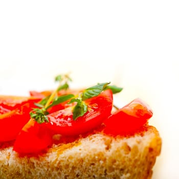 Italian tomato bruschetta with thyme and mint leaves 