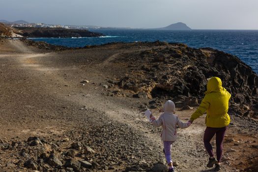 mother with two kids hiking in mountains