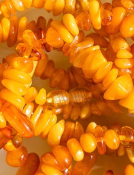 Solar beads of fiery amber on onyx marble background. Natural stone backdrop.