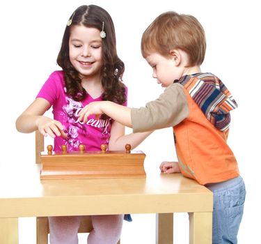 brother and sister enthusiastically collected puzzle.Isolated on white background portrait.