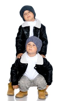 Studio portrait of boys in black leather jackets.Isolated on white background.