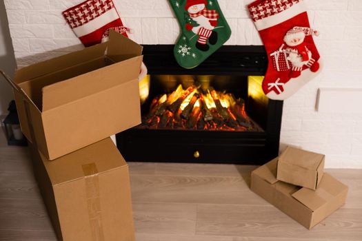 delivery christmas gifts. delivery boxes near fireplace before christmas